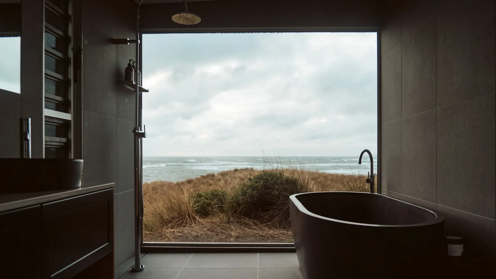 Spa bathroom with dark slate tiling and freestanding bath