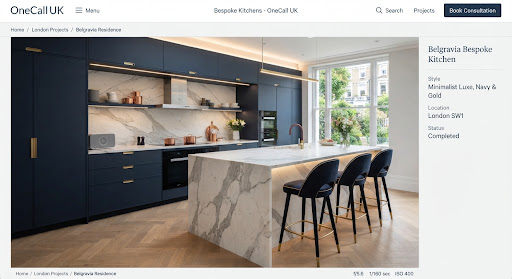 Navy cabinetry kitchen with marble waterfall island