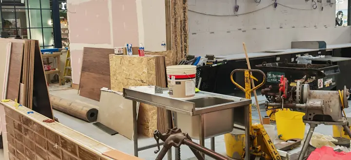 Tiled counter face and timber edge detailing being installed