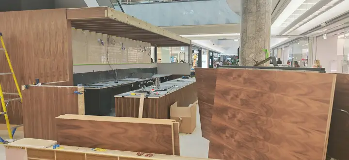 Later-stage fit-out with completed floor areas and counter carcasses